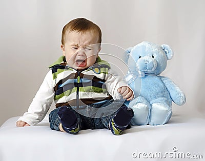 baby-crying-with-teddy-bear-thumb14236305.jpg